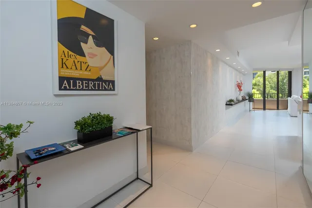 a bedroom with a large bed and a flat screen television