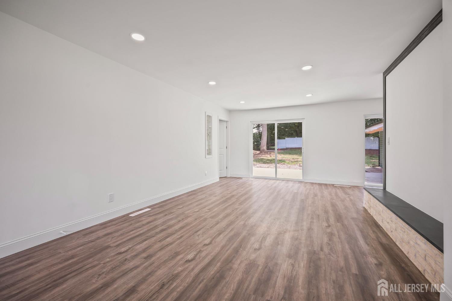 12 Dillon Road Kendall Park, NJ 08824 - Photo 14 of 48 wooden floor in an empty room with a window