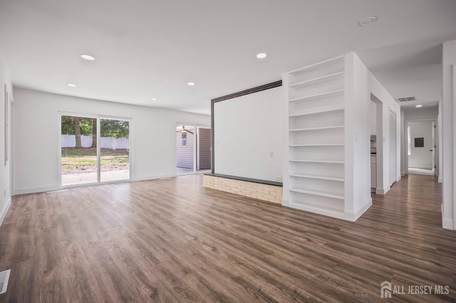 12 Dillon Road Kendall Park, NJ 08824 - Photo 15 of 48 a view of empty room with wooden floor and window