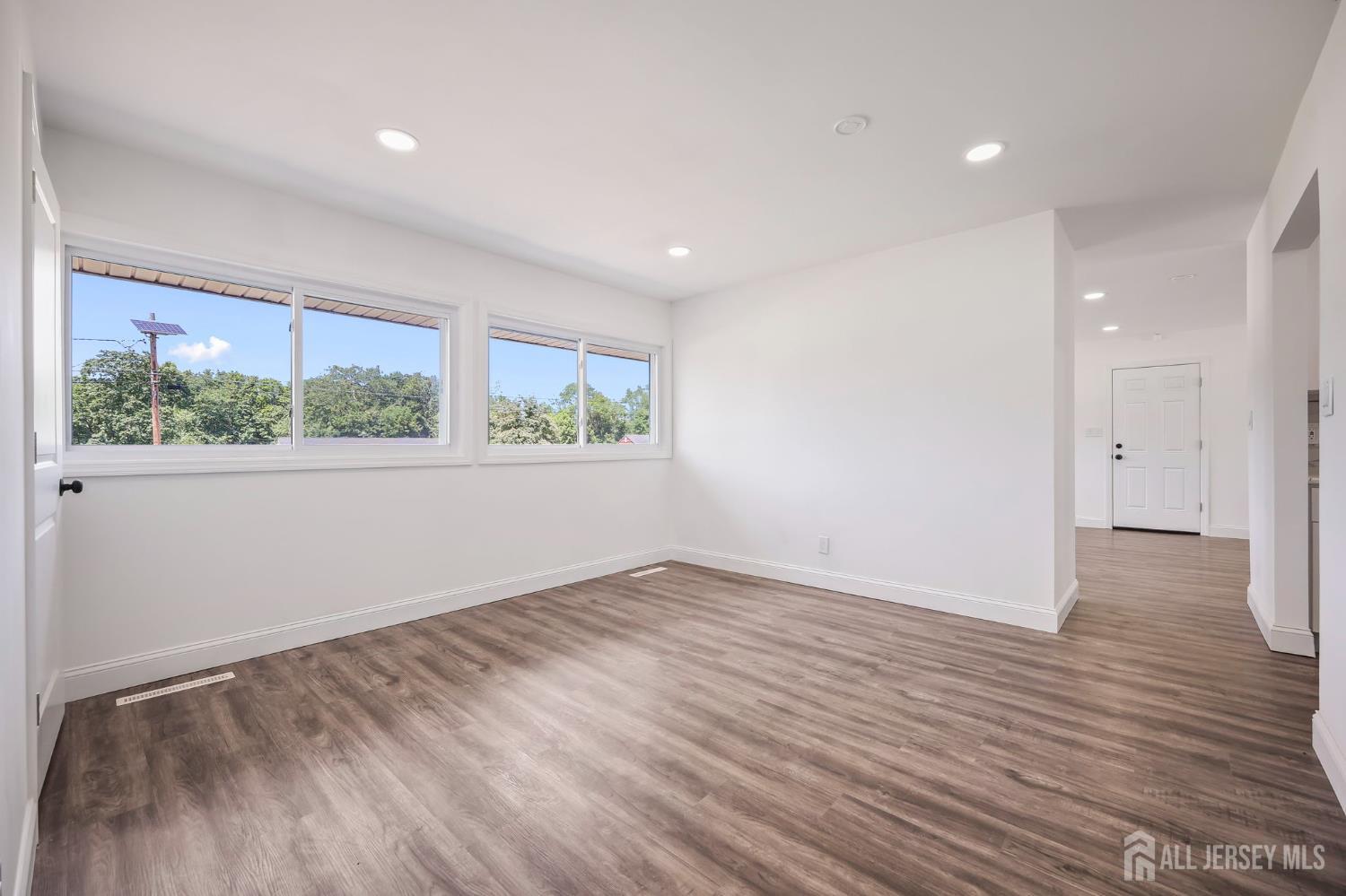 12 Dillon Road Kendall Park, NJ 08824 - Photo 18 of 48 an empty room with wooden floor and windows