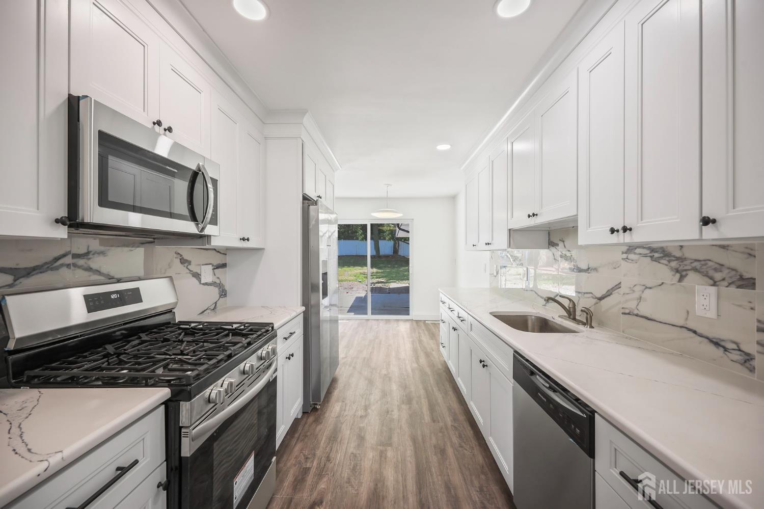 12 Dillon Road Kendall Park, NJ 08824 - Photo 2 of 48 a kitchen with a sink stove and microwave