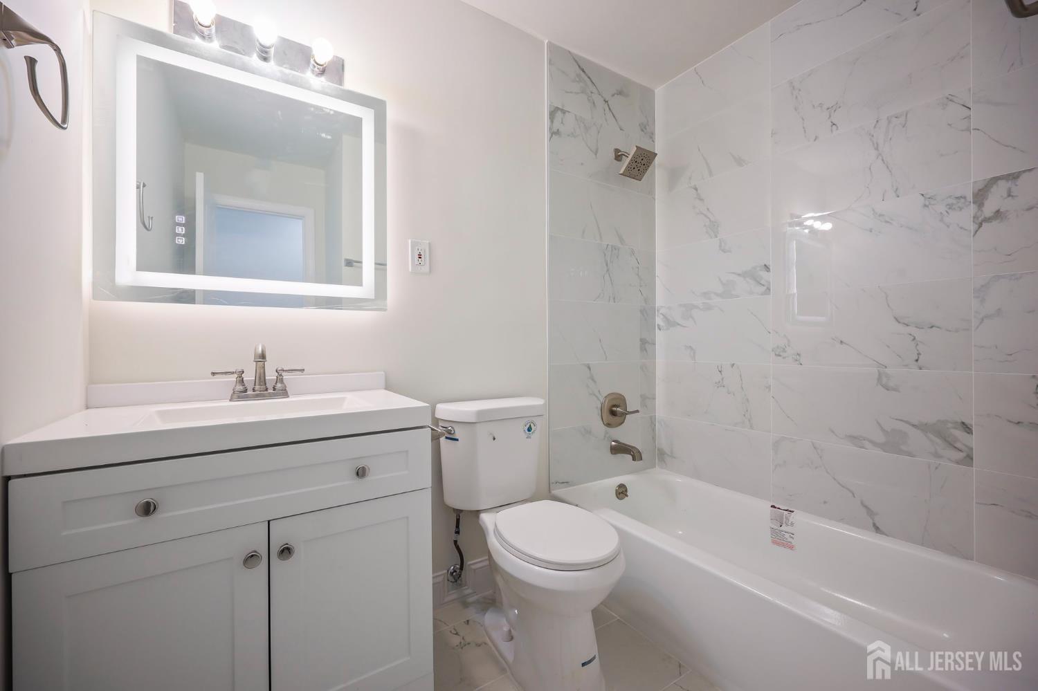 12 Dillon Road Kendall Park, NJ 08824 - Photo 21 of 48 a bathroom with a granite countertop sink a toilet and shower