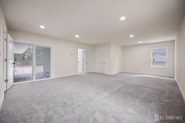 a view of an empty room with glass door