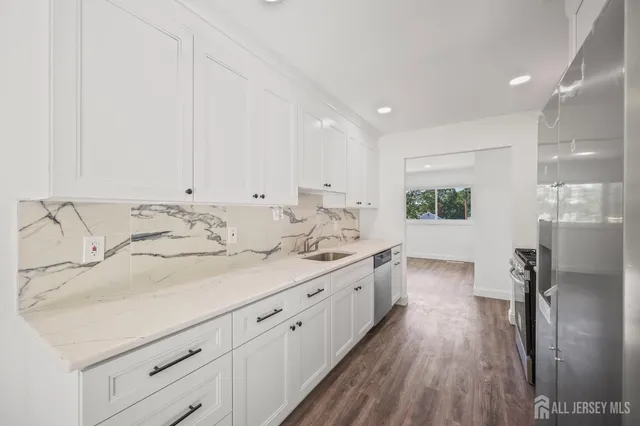 a spacious bathroom with a double vanity sink and a mirror