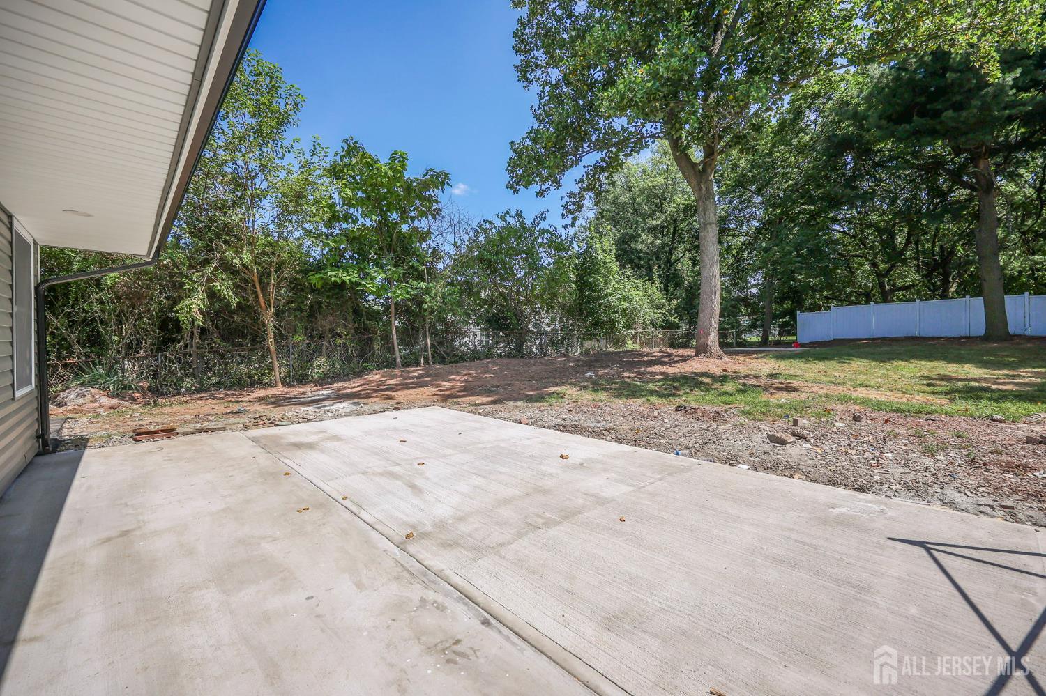 12 Dillon Road Kendall Park, NJ 08824 - Photo 40 of 48 a view of a backyard with large trees