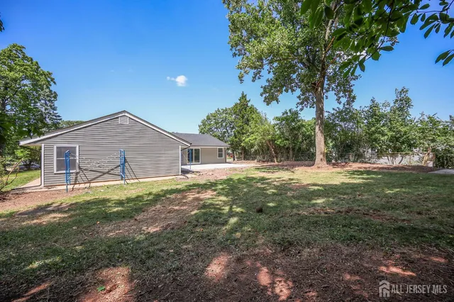 a view of a house with yard and a tree