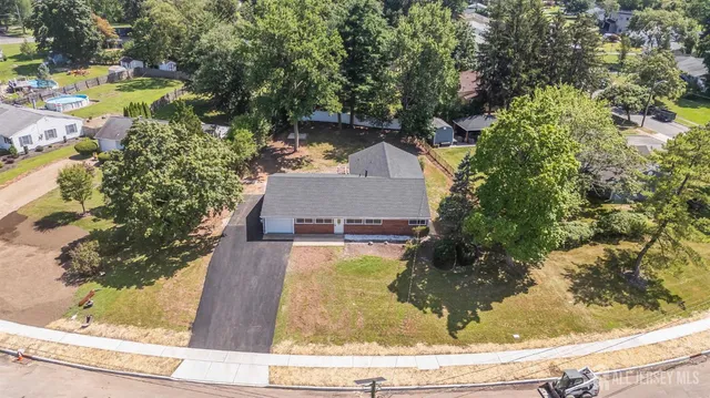 a view of a house with a yard and sitting area