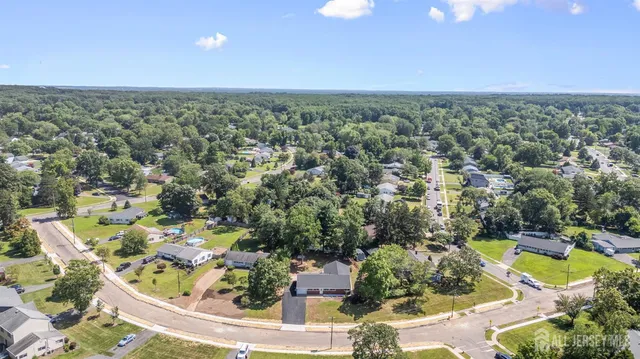 an aerial view of residential houses with outdoor space and swimming pool