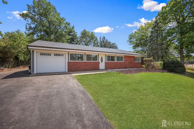a front view of house with yard and green space