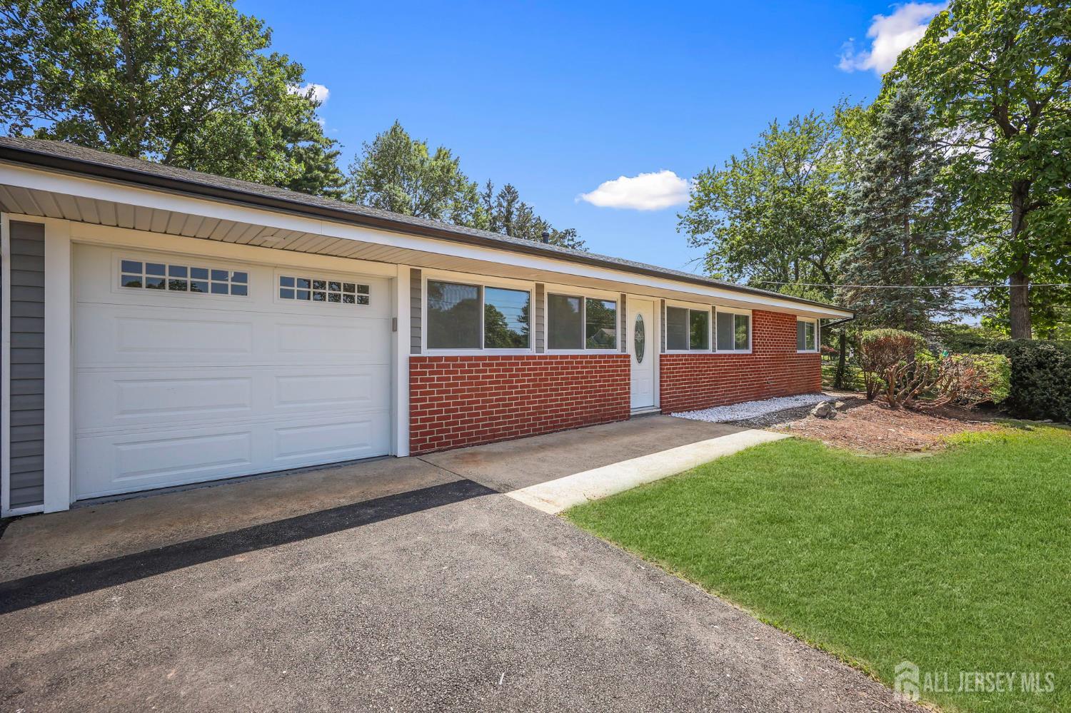12 Dillon Road Kendall Park, NJ 08824 - Photo 10 of 48 a view of backyard with large trees and plants