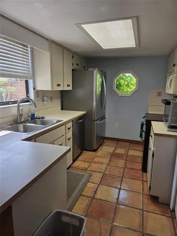 a kitchen with a cabinets and window
