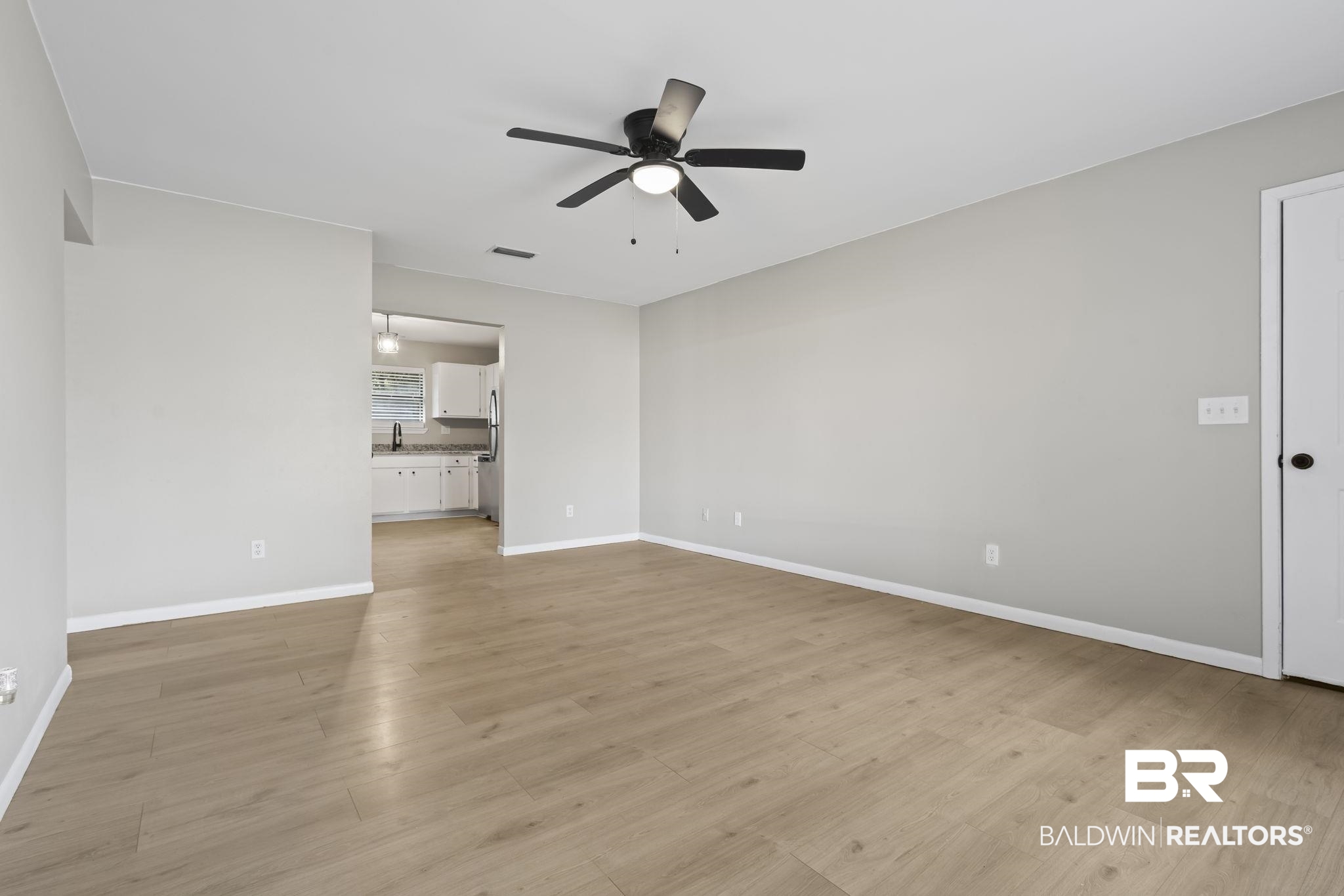 309 West Roosevelt Avenue Foley, AL 36535 - Photo 16 of 60 Unfurnished living room with ceiling fan, sink, and light hardwood / wood-style flooring