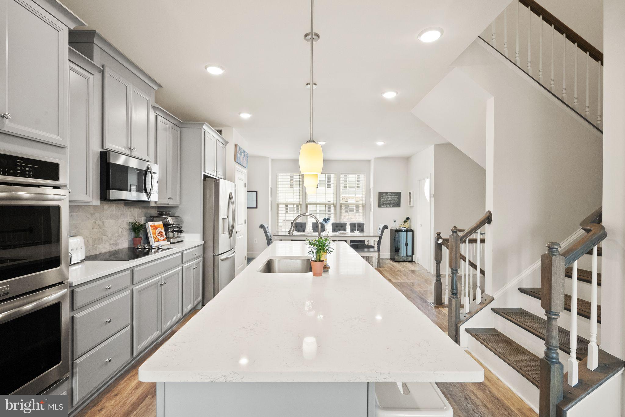 13803 Litespeed Way Gainesville, VA 20155 - Photo 11 of 37 a large white kitchen with lots of counter space a sink appliances and cabinets