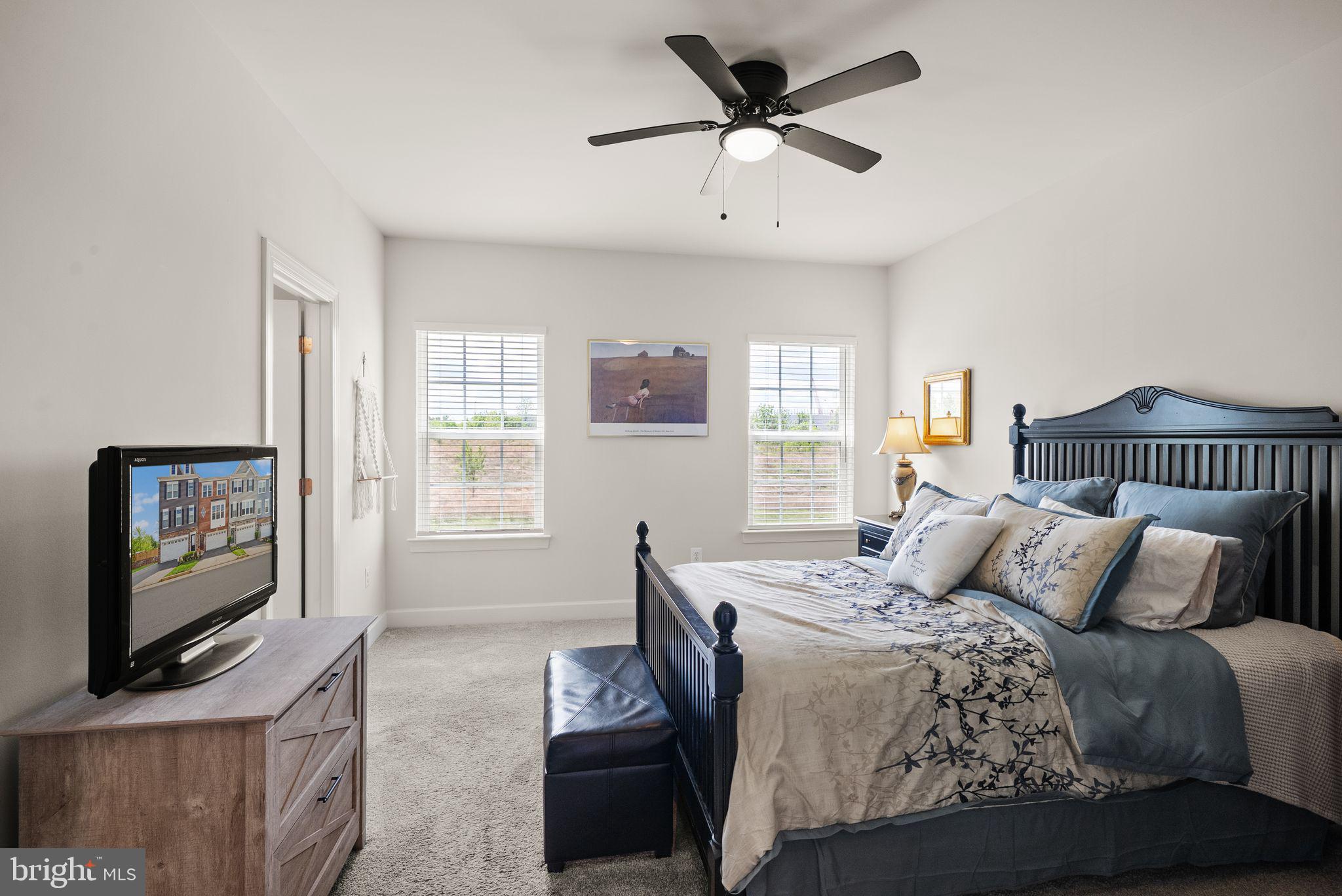 13803 Litespeed Way Gainesville, VA 20155 - Photo 18 of 37 a bedroom with a bed and a flat screen tv