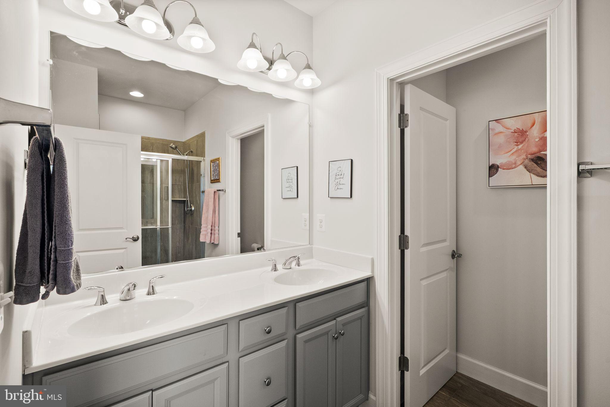 13803 Litespeed Way Gainesville, VA 20155 - Photo 20 of 37 a bathroom with a double vanity sink mirror and double