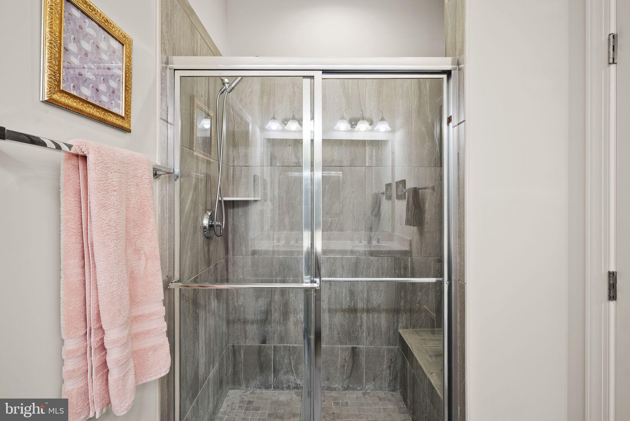 13803 Litespeed Way Gainesville, VA 20155 - Photo 21 of 37 a bathroom with a glass shower door