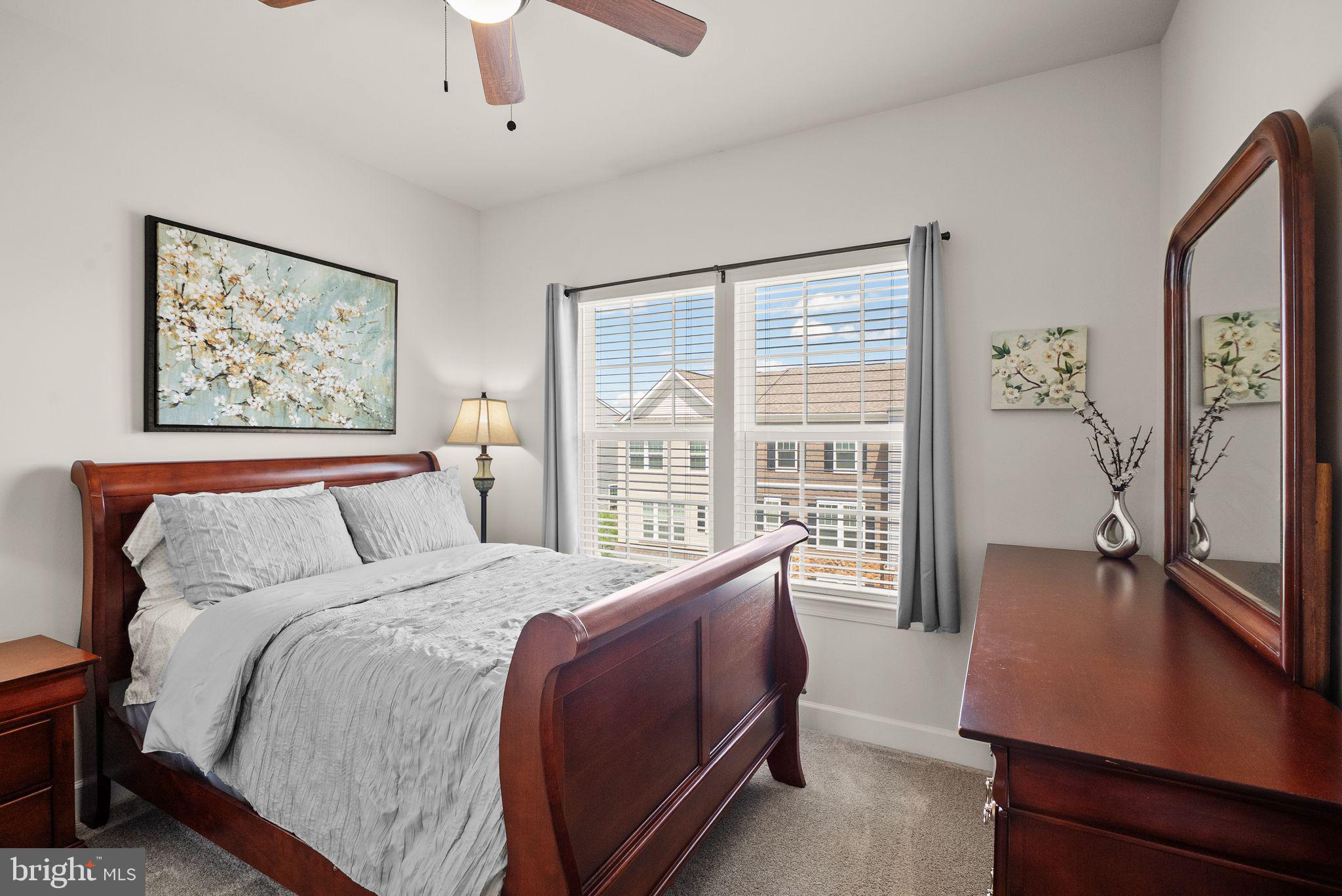 13803 Litespeed Way Gainesville, VA 20155 - Photo 23 of 37 a large bedroom with a large bed and a large window