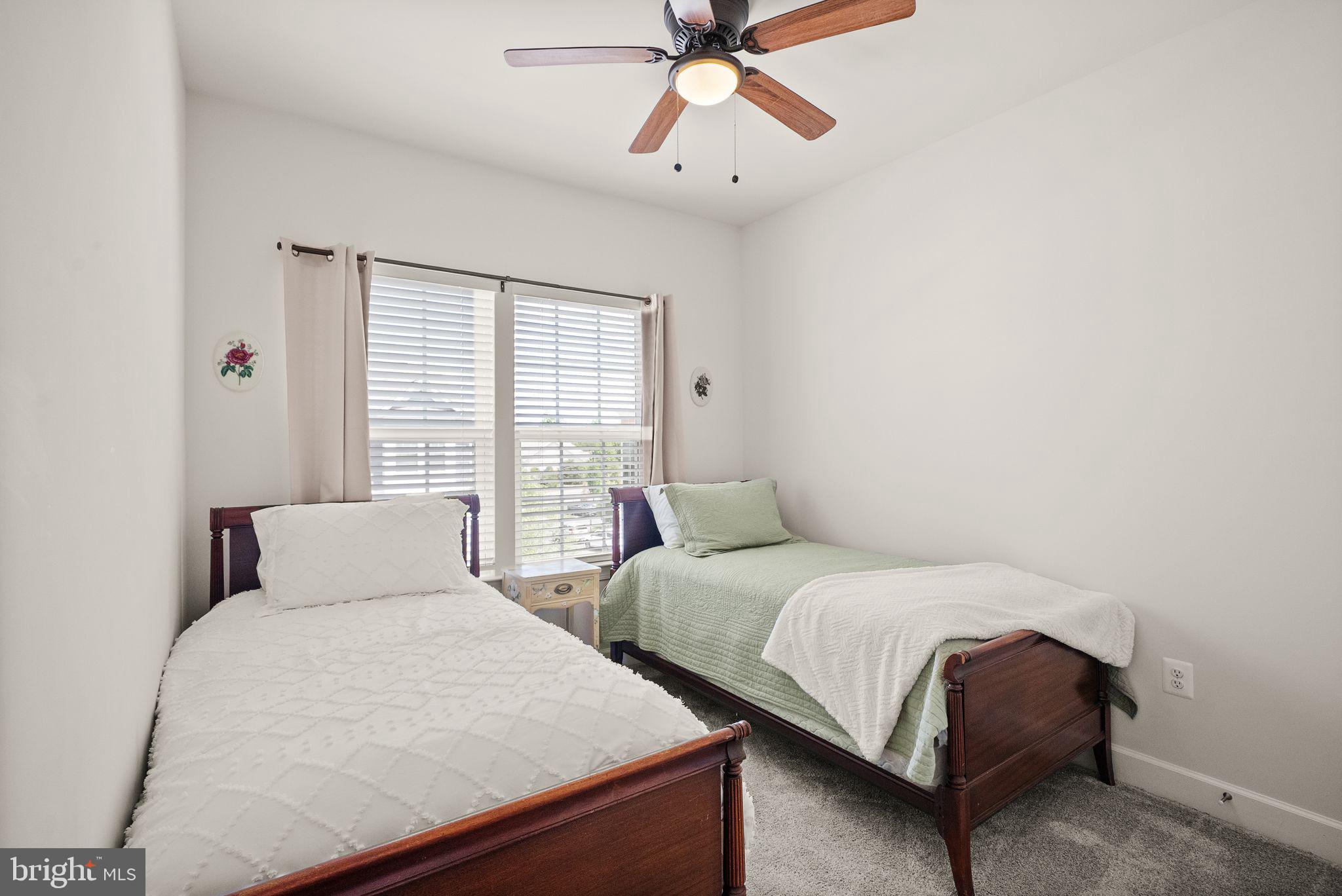 13803 Litespeed Way Gainesville, VA 20155 - Photo 25 of 37 a bedroom with two beds and a chandelier