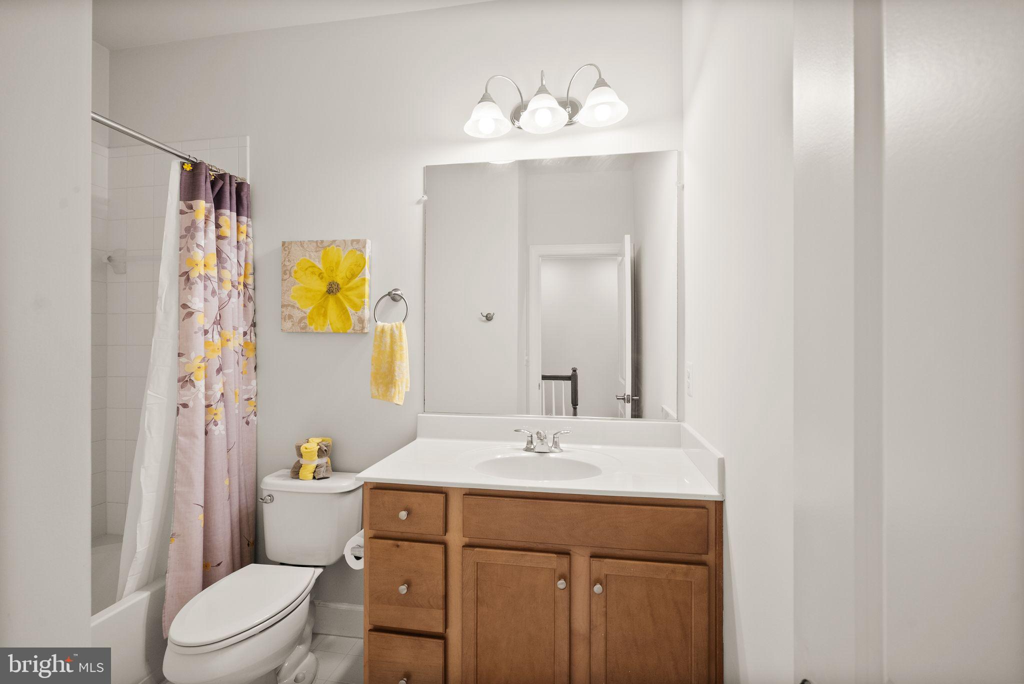 13803 Litespeed Way Gainesville, VA 20155 - Photo 28 of 37 a bathroom with a sink a toilet and mirror
