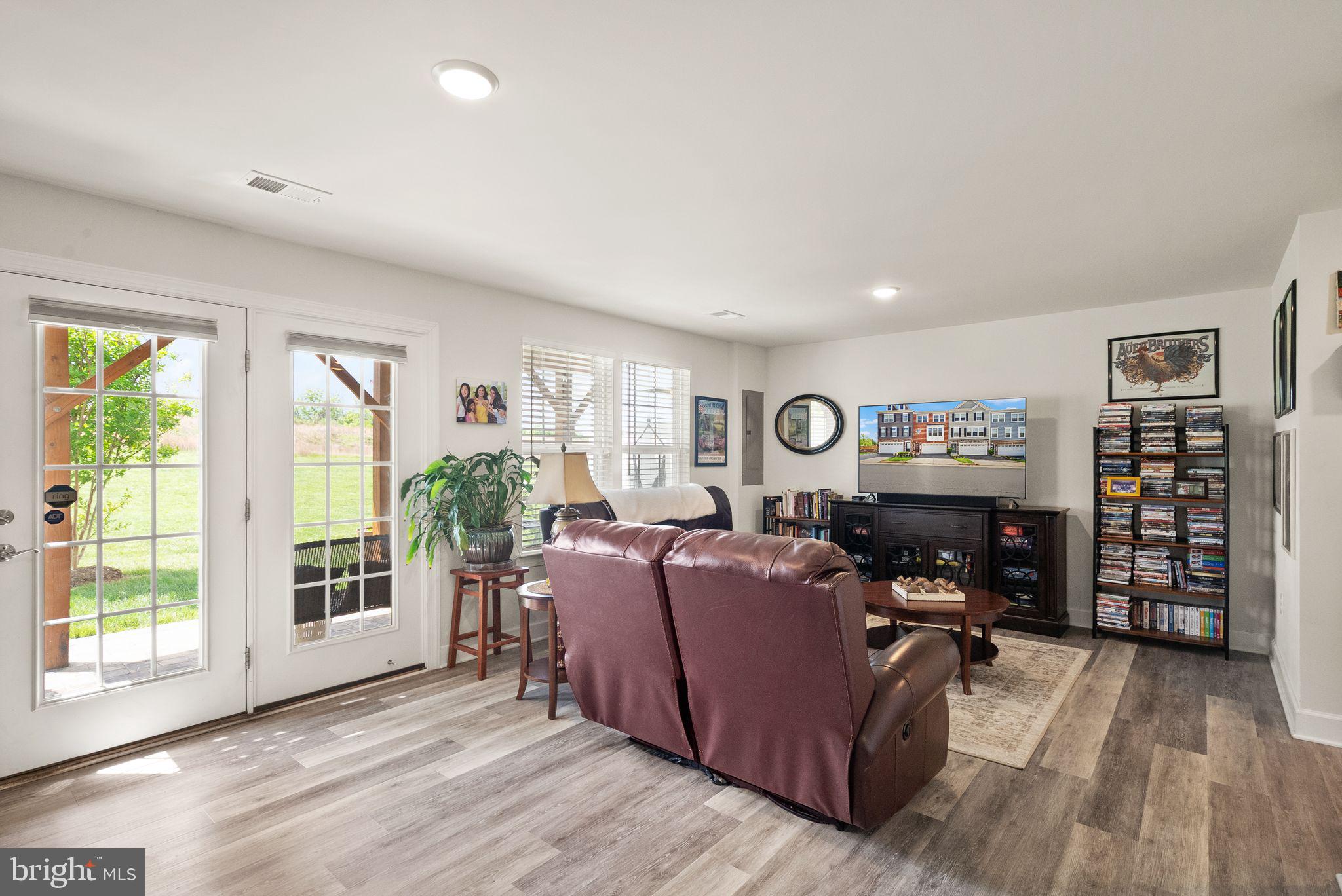 13803 Litespeed Way Gainesville, VA 20155 - Photo 29 of 37 a living room with furniture a fireplace and a flat screen tv