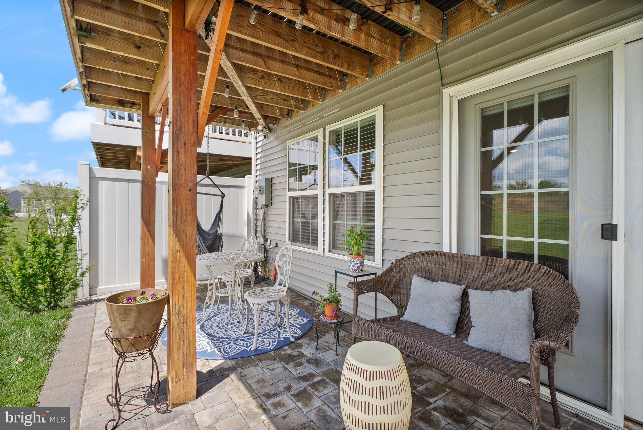 13803 Litespeed Way Gainesville, VA 20155 - Photo 33 of 37 a outdoor space with patio the couches and a potted plant on the table
