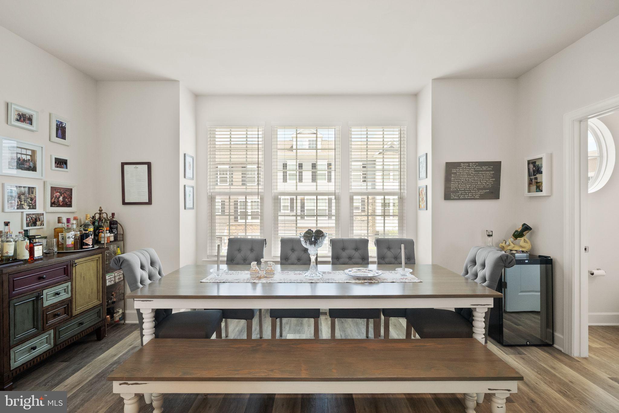 13803 Litespeed Way Gainesville, VA 20155 - Photo 4 of 37 a view of a dining room with furniture window and wooden floor
