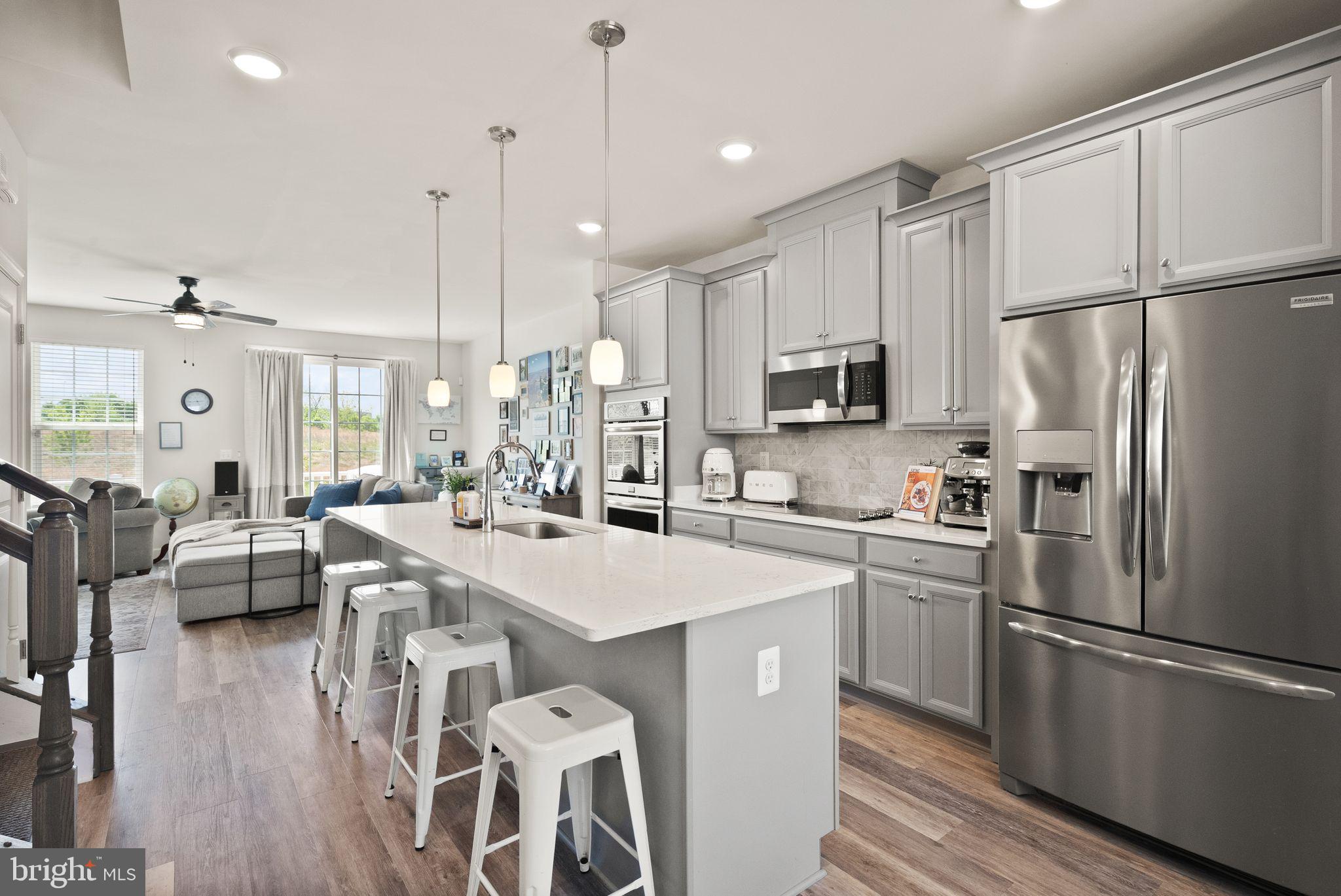 13803 Litespeed Way Gainesville, VA 20155 - Photo 7 of 37 a kitchen with counter top space a sink appliances and cabinets