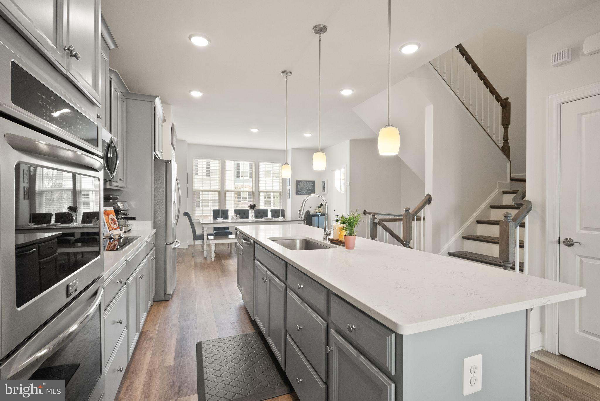 13803 Litespeed Way Gainesville, VA 20155 - Photo 10 of 37 a kitchen with counter top space a sink stainless steel appliances and cabinets