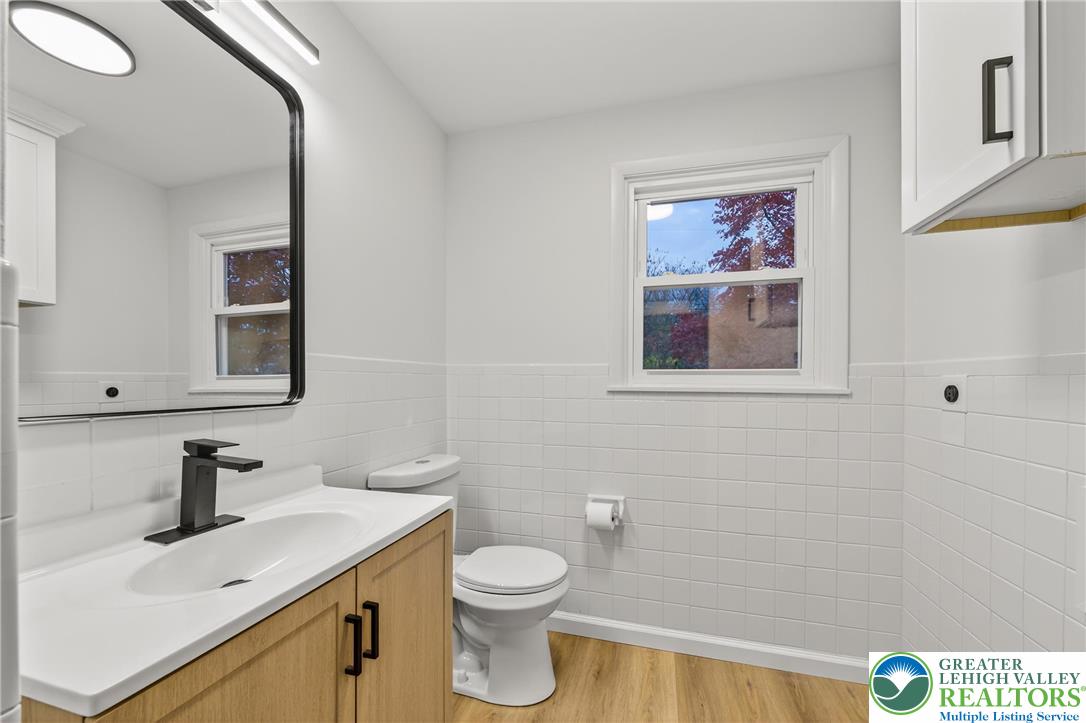 1285 Stafore Drive Bethlehem, PA 18017 - Photo 19 of 56 a bathroom with a toilet sink vanity and mirror