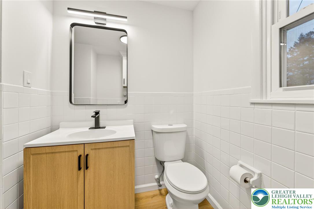 1285 Stafore Drive Bethlehem, PA 18017 - Photo 20 of 56 a bathroom with a toilet sink vanity and mirror