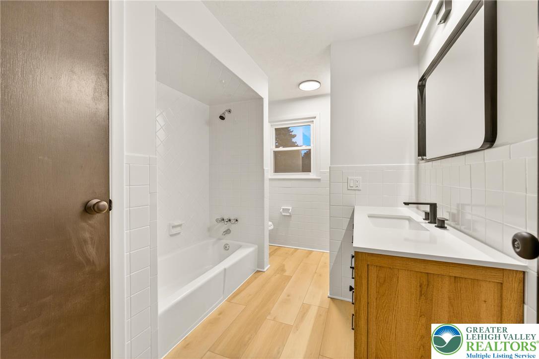 1285 Stafore Drive Bethlehem, PA 18017 - Photo 23 of 56 a bathroom with a tub sink and mirror