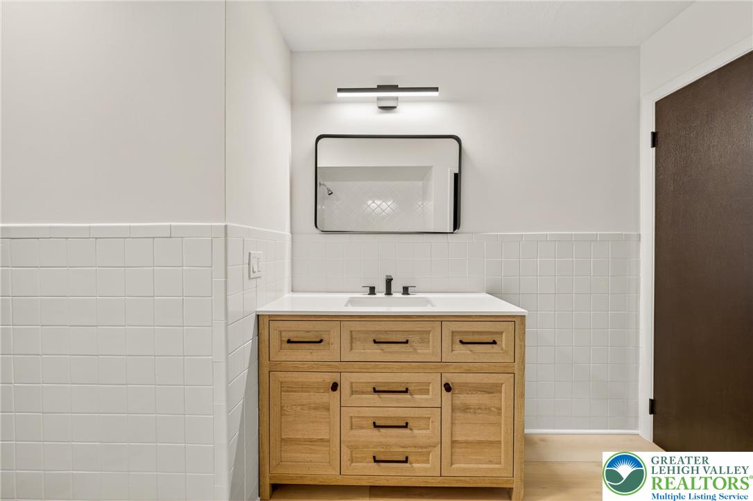 1285 Stafore Drive Bethlehem, PA 18017 - Photo 24 of 56 a bathroom with a sink and a mirror