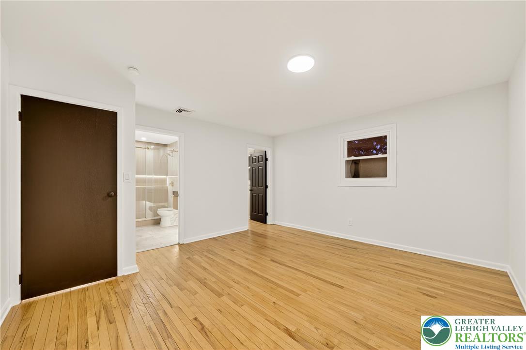 1285 Stafore Drive Bethlehem, PA 18017 - Photo 25 of 56 a bedroom with a bed and a painting on the wall