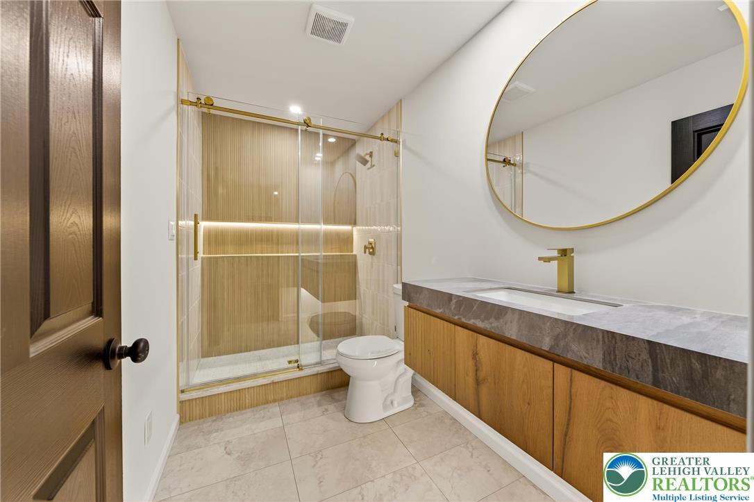 1285 Stafore Drive Bethlehem, PA 18017 - Photo 27 of 56 a bathroom with a granite countertop sink a toilet and shower