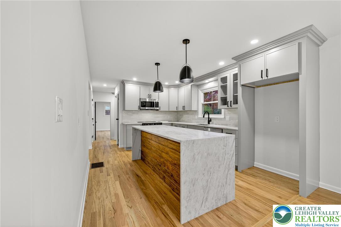 1285 Stafore Drive Bethlehem, PA 18017 - Photo 10 of 56 a large kitchen with stainless steel appliances a refrigerator and a wooden floor