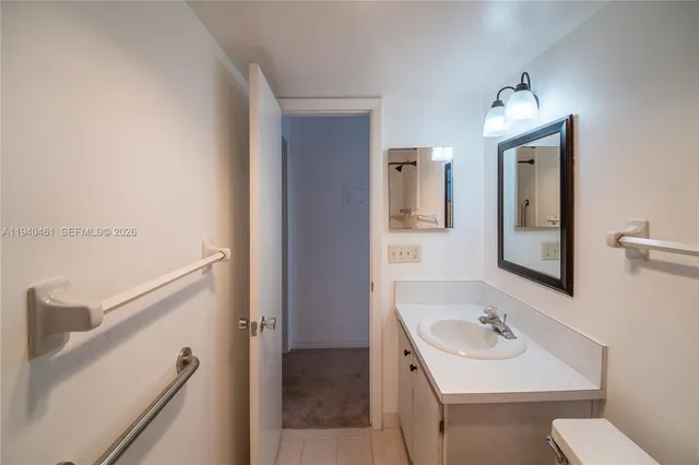 a bathroom with a sink toilet and mirror