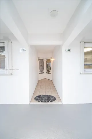 a view of a livingroom with wooden floor and kitchen space