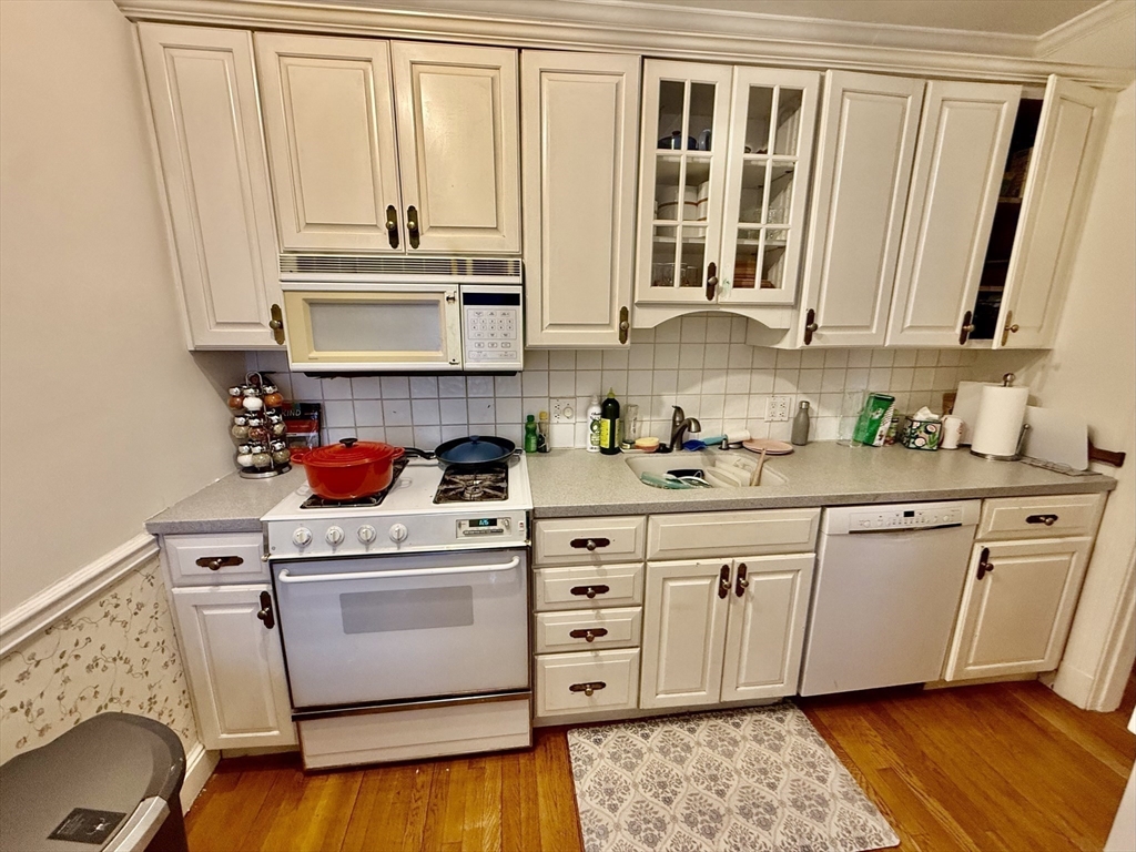 116 Park Street, Unit 2 Brookline, MA 02446 - Photo 5 of 10 a kitchen with white cabinets and white appliances
