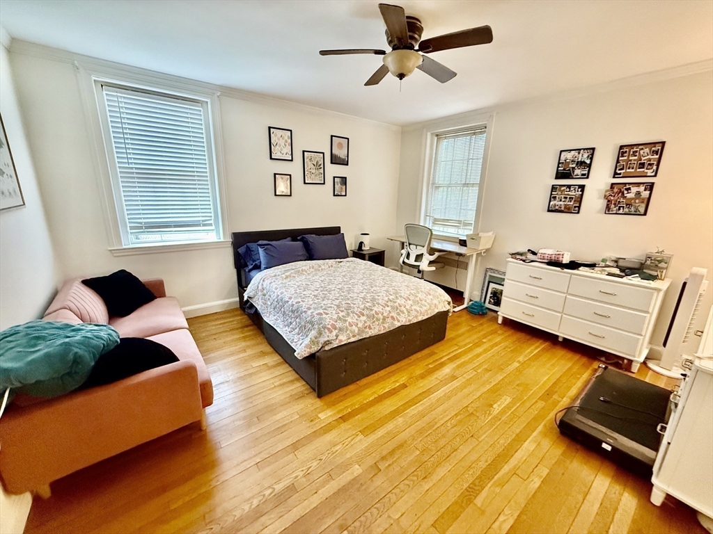 116 Park Street, Unit 2 Brookline, MA 02446 - Photo 7 of 10 a bedroom with a bed and wooden floor