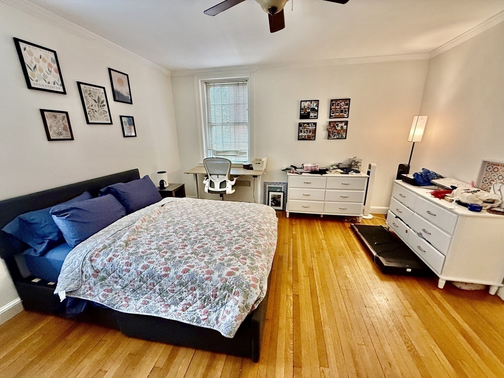 116 Park Street, Unit 2 Brookline, MA 02446 - Photo 8 of 10 a bedroom with a bed and wooden floor