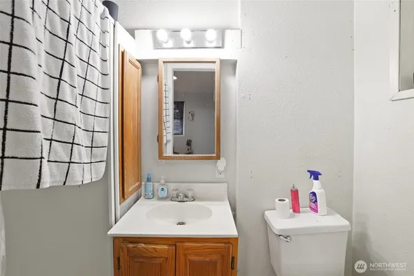 a bathroom with a sink toilet and a mirror