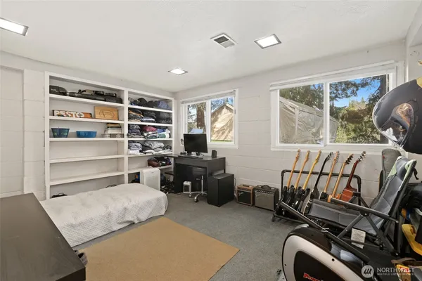 a bedroom with furniture and a window