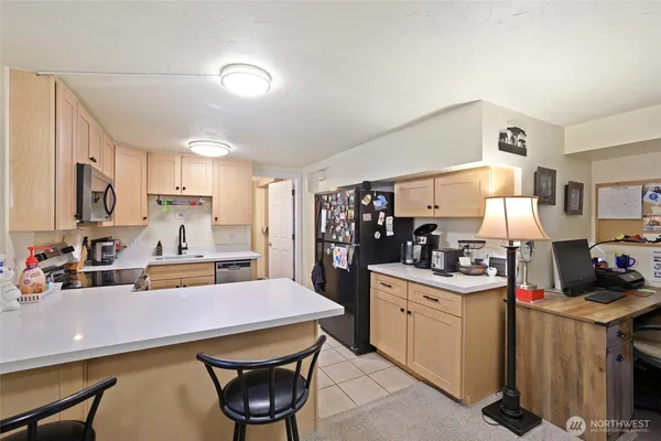 a kitchen with stainless steel appliances a sink stove and refrigerator