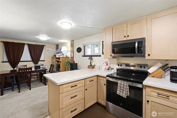 a kitchen with a sink stove and cabinets