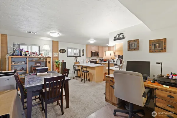 a view of a dining room with furniture and a kitchen