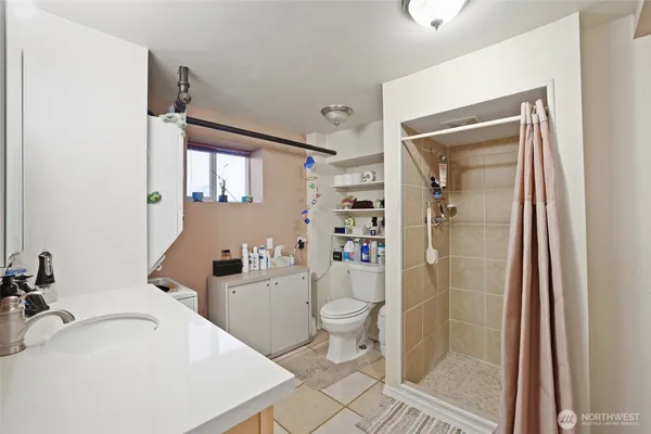 a bathroom with a sink toilet and shower