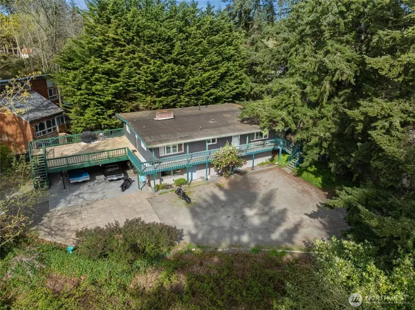 an aerial view of a house with a yard swimming pool patio and outdoor seating