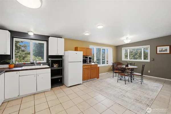 a kitchen with a refrigerator and a sink