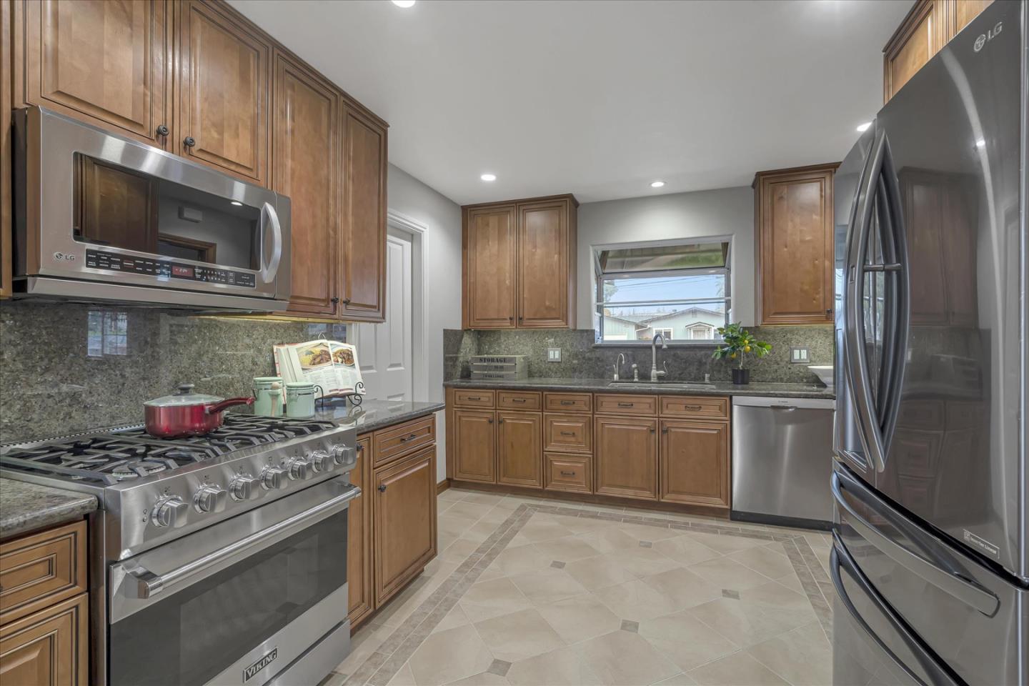 1867 Queens Road Concord, CA 94519 - Photo 12 of 30 a kitchen with stainless steel appliances granite countertop a stove microwave and refrigerator