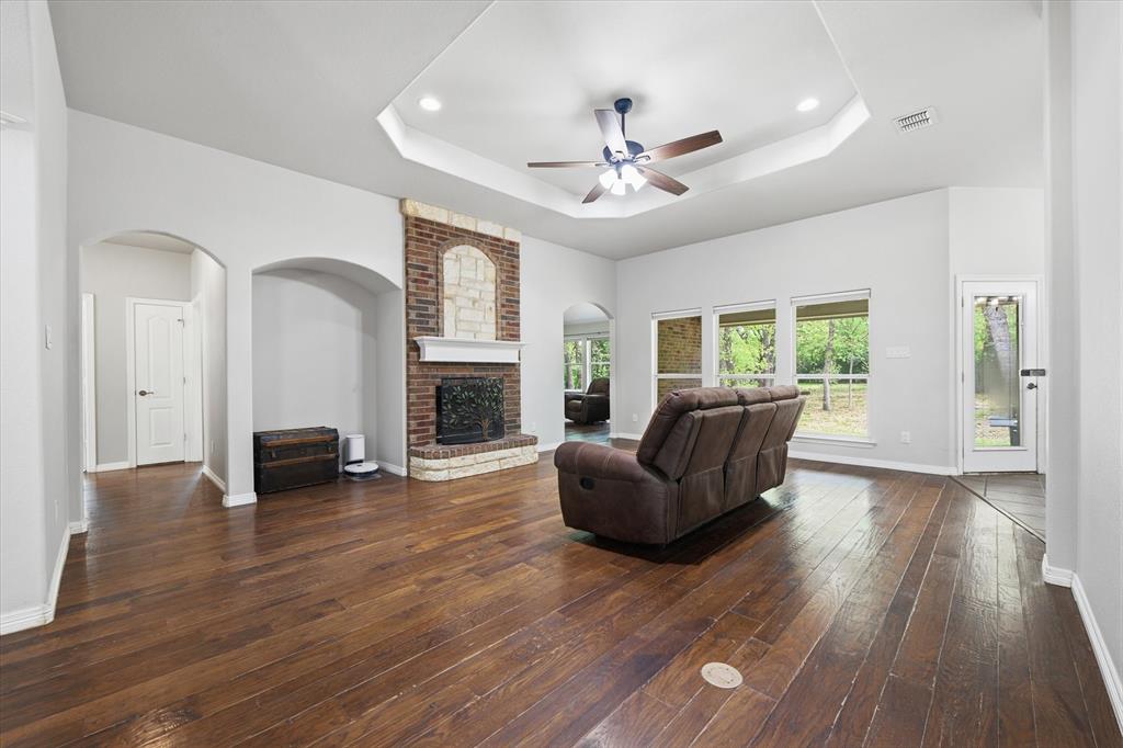 5992 Red Bud Road Fort Worth, TX 76135 - Photo 11 of 40 a living room with furniture and a fireplace